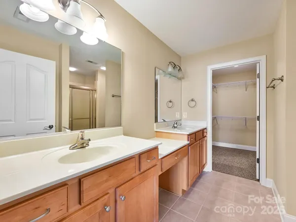 a spacious bathroom with a double vanity sink mirror and double