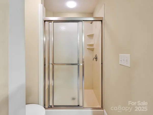 a bathroom with a glass shower door
