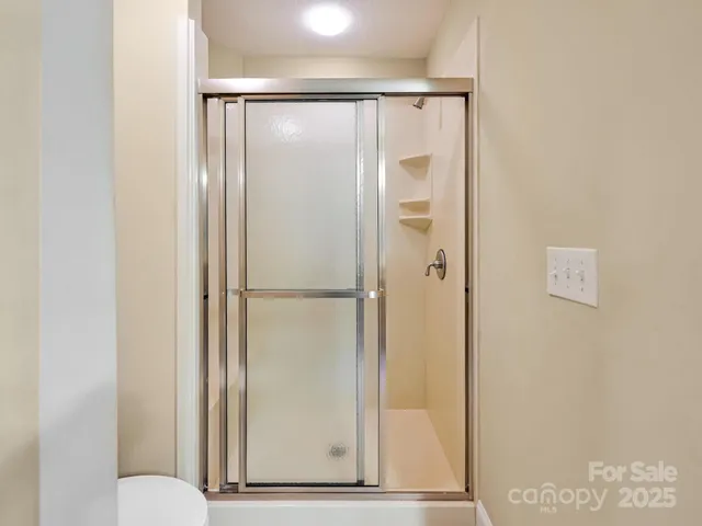 a bathroom with a glass shower door