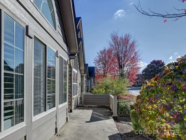 a view of a balcony with flower plants