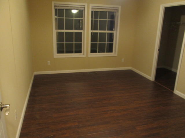 2542 Porters Mountain Road Blue Ridge, VA 24064 - Photo 23 of 31 an empty room with wooden floor and windows
