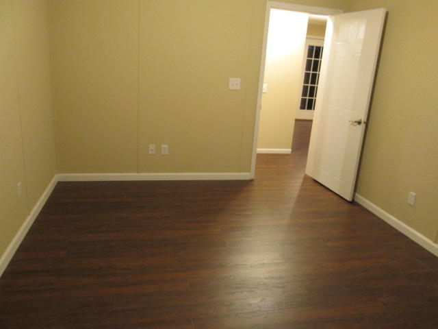 2542 Porters Mountain Road Blue Ridge, VA 24064 - Photo 24 of 31 an empty room with wooden floor and windows