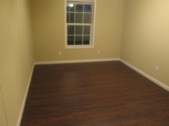 2542 Porters Mountain Road Blue Ridge, VA 24064 - Photo 26 of 31 a view of an empty room with wooden floor and a window