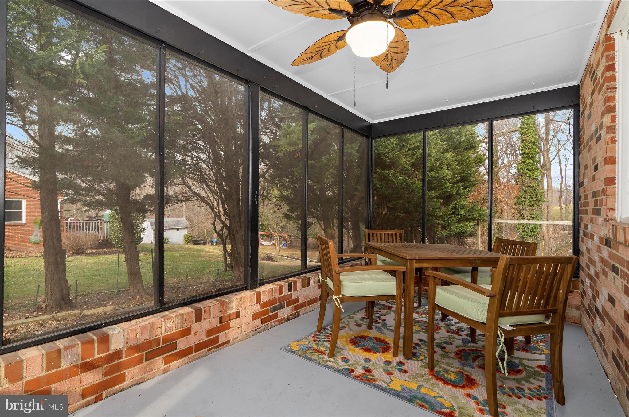19 Well Street Huntingtown, MD 20639 - Photo 12 of 44 a view of a patio with a table chairs and a floor to ceiling window
