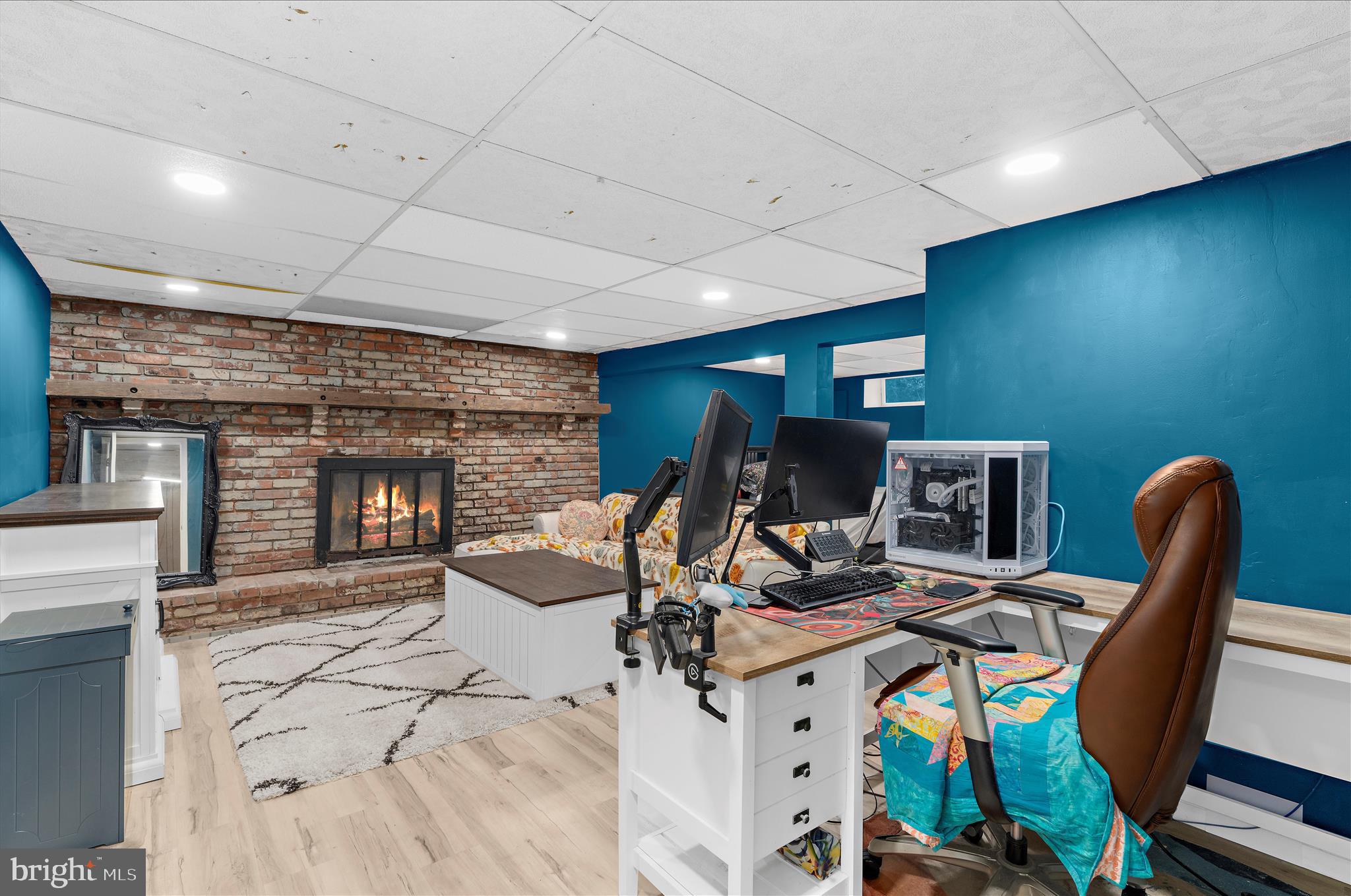 19 Well Street Huntingtown, MD 20639 - Photo 31 of 44 a work room with furniture a flat screen tv and a floor to ceiling window