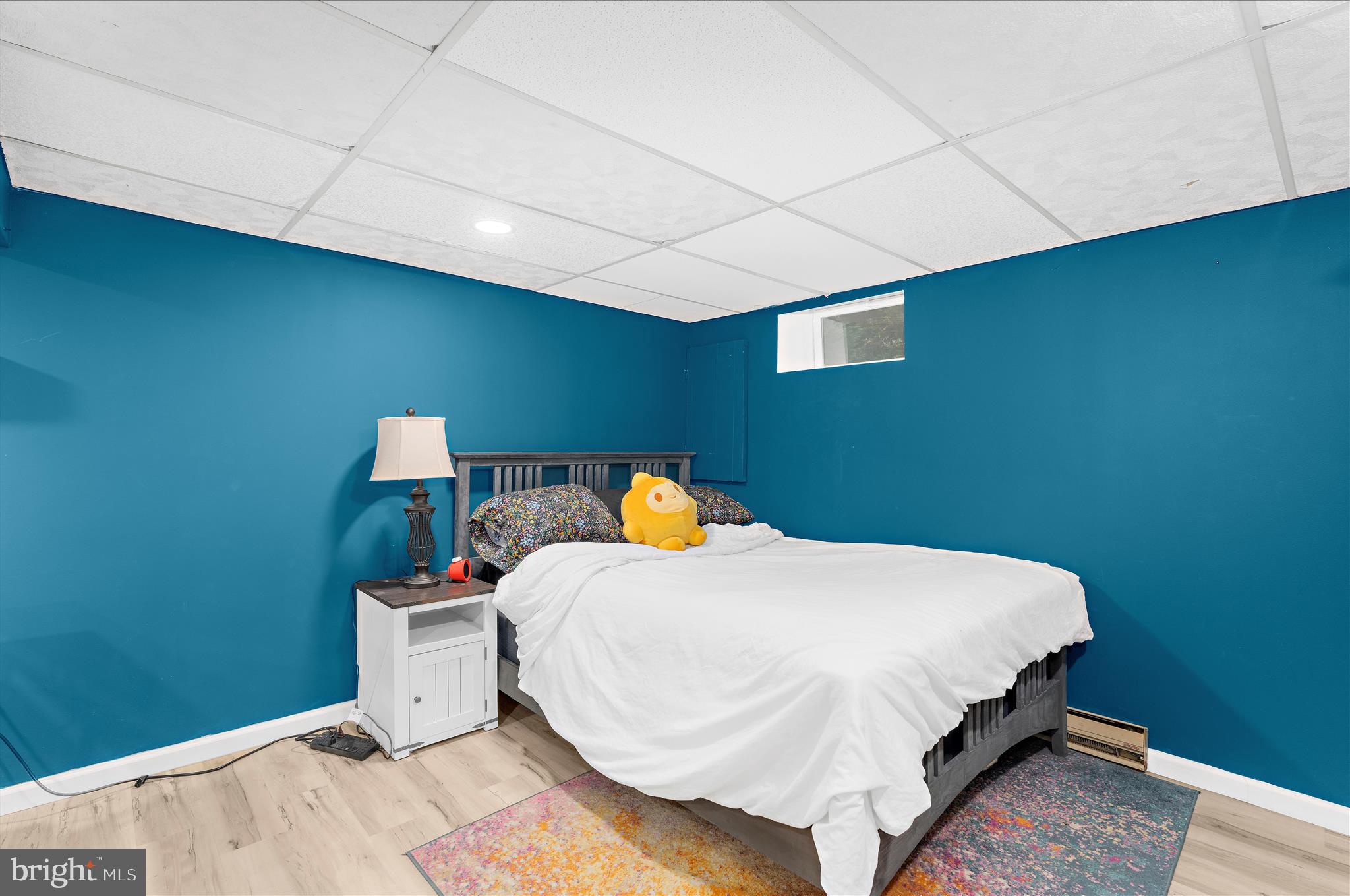 19 Well Street Huntingtown, MD 20639 - Photo 33 of 44 a bed sitting in a room next to a lamp