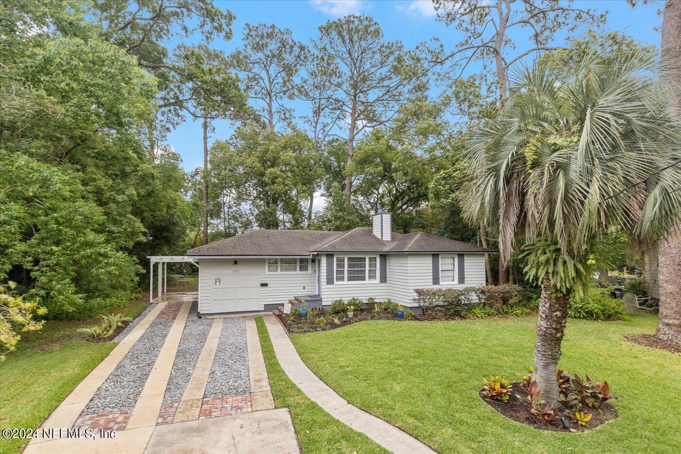 a view of a house with a yard deck and a slide