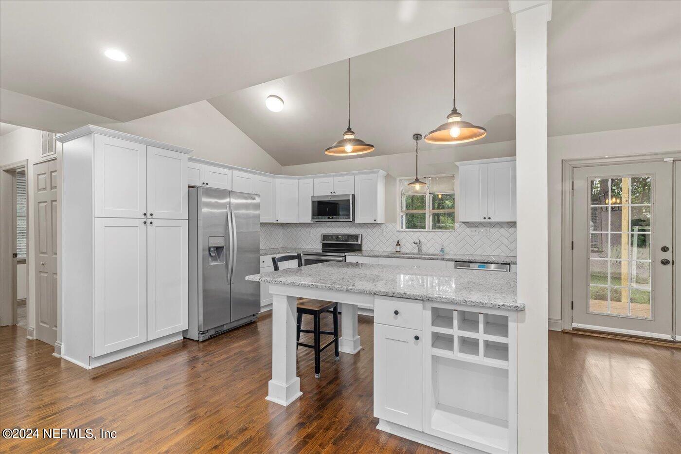 1273 Lechlade Circle Jacksonville, FL 32205 - Photo 12 of 33 a kitchen with stainless steel appliances granite countertop a stove a refrigerator and a microwave