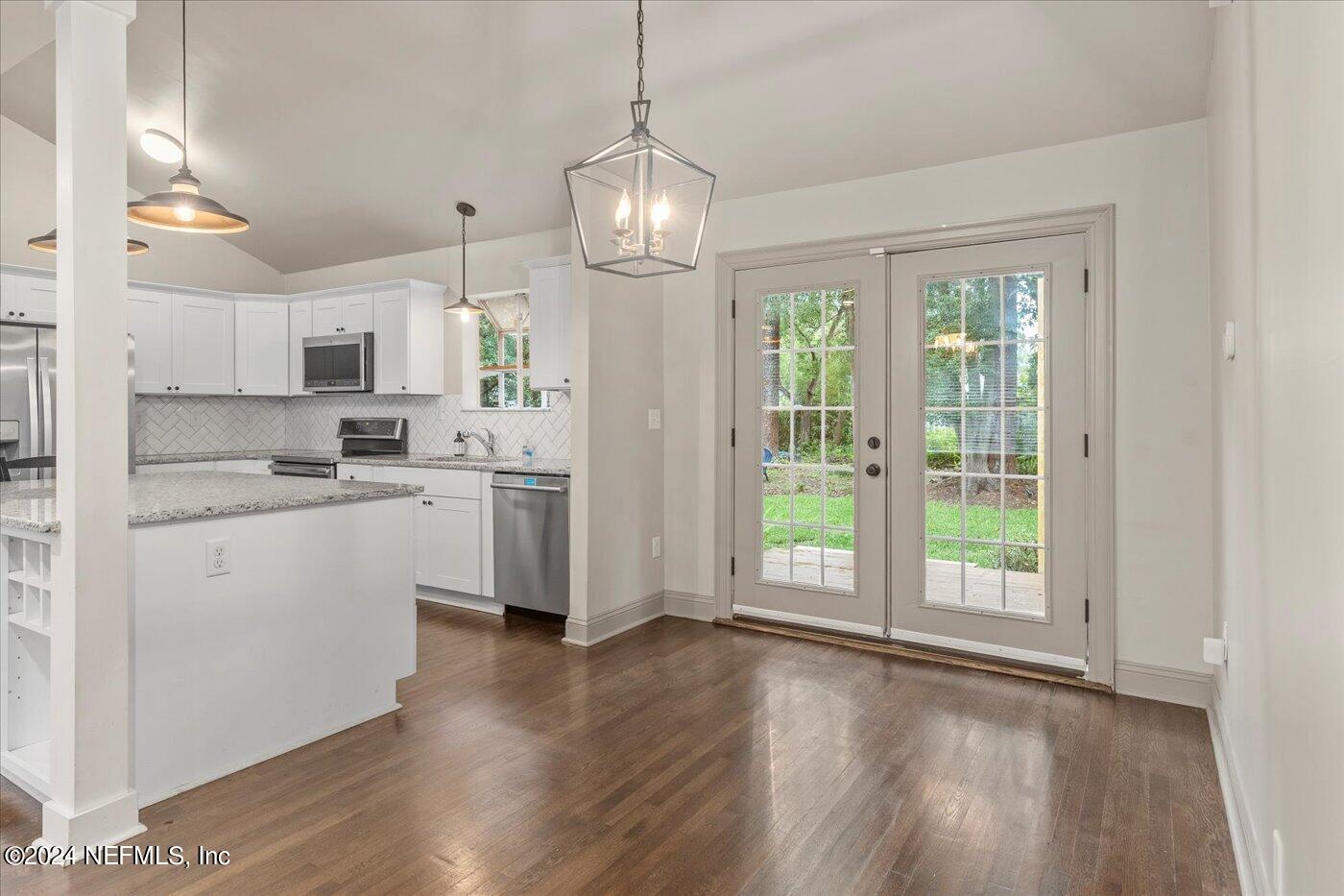 1273 Lechlade Circle Jacksonville, FL 32205 - Photo 16 of 33 a kitchen that has a lot of white cabinets and wooden floor