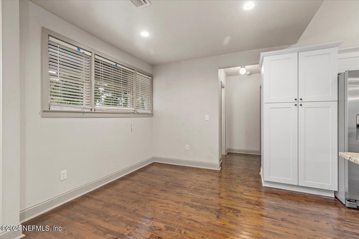 1273 Lechlade Circle Jacksonville, FL 32205 - Photo 17 of 33 a view of an empty room with wooden floor and a window