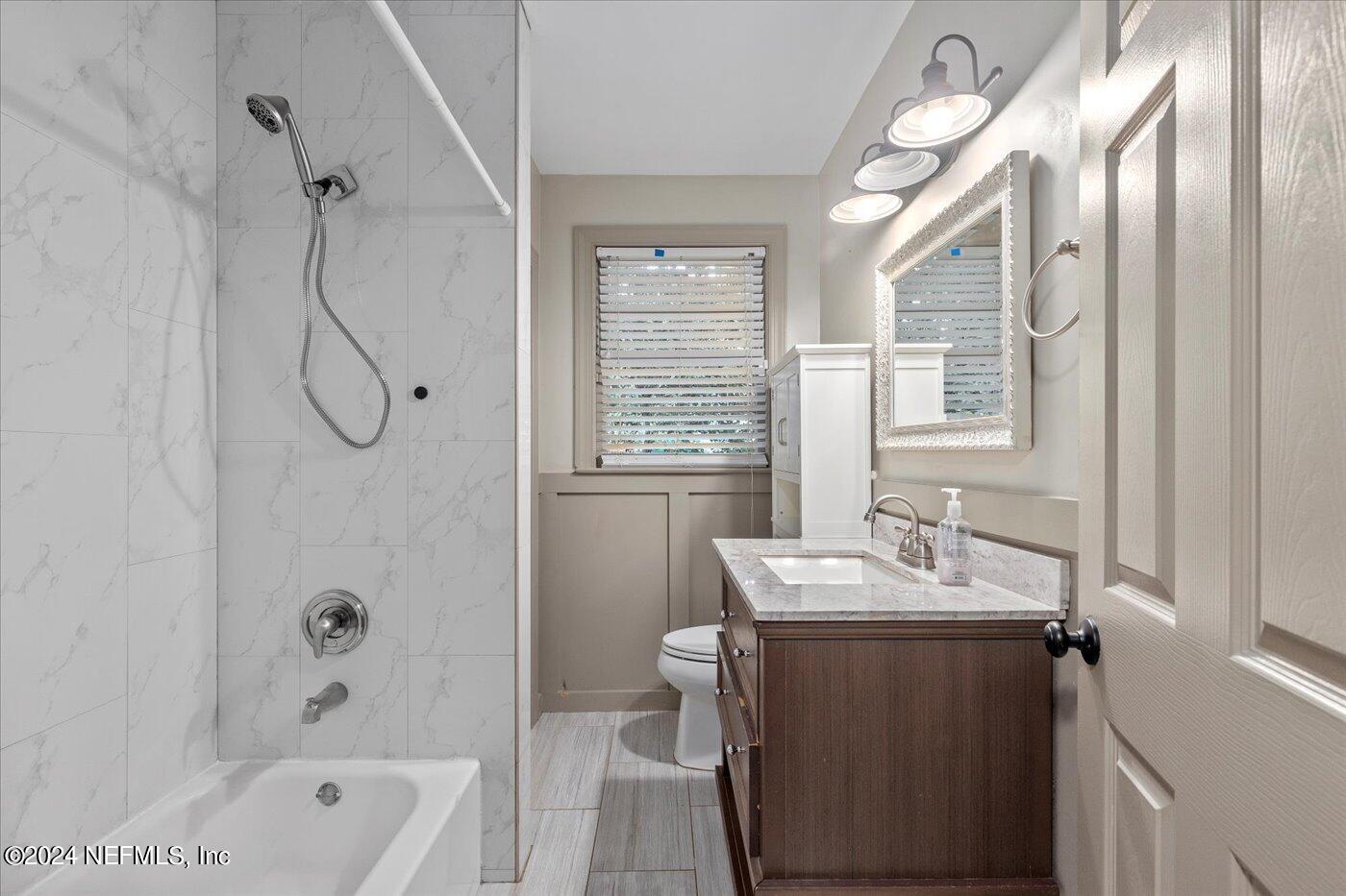 1273 Lechlade Circle Jacksonville, FL 32205 - Photo 23 of 33 a bathroom with a granite countertop sink a toilet and shower