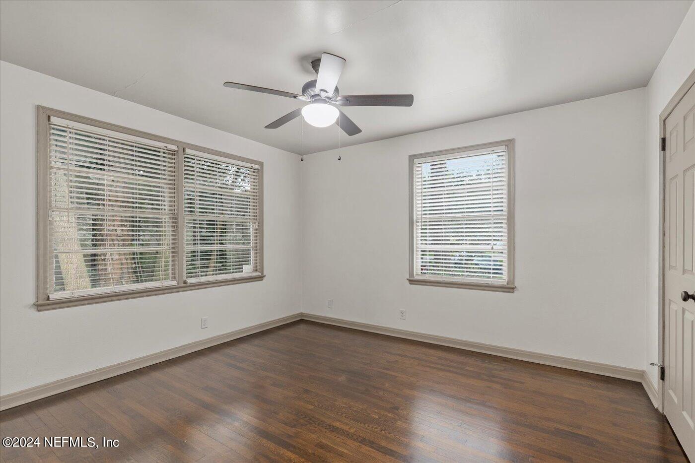 1273 Lechlade Circle Jacksonville, FL 32205 - Photo 25 of 33 a view of an empty room with wooden floor and a window