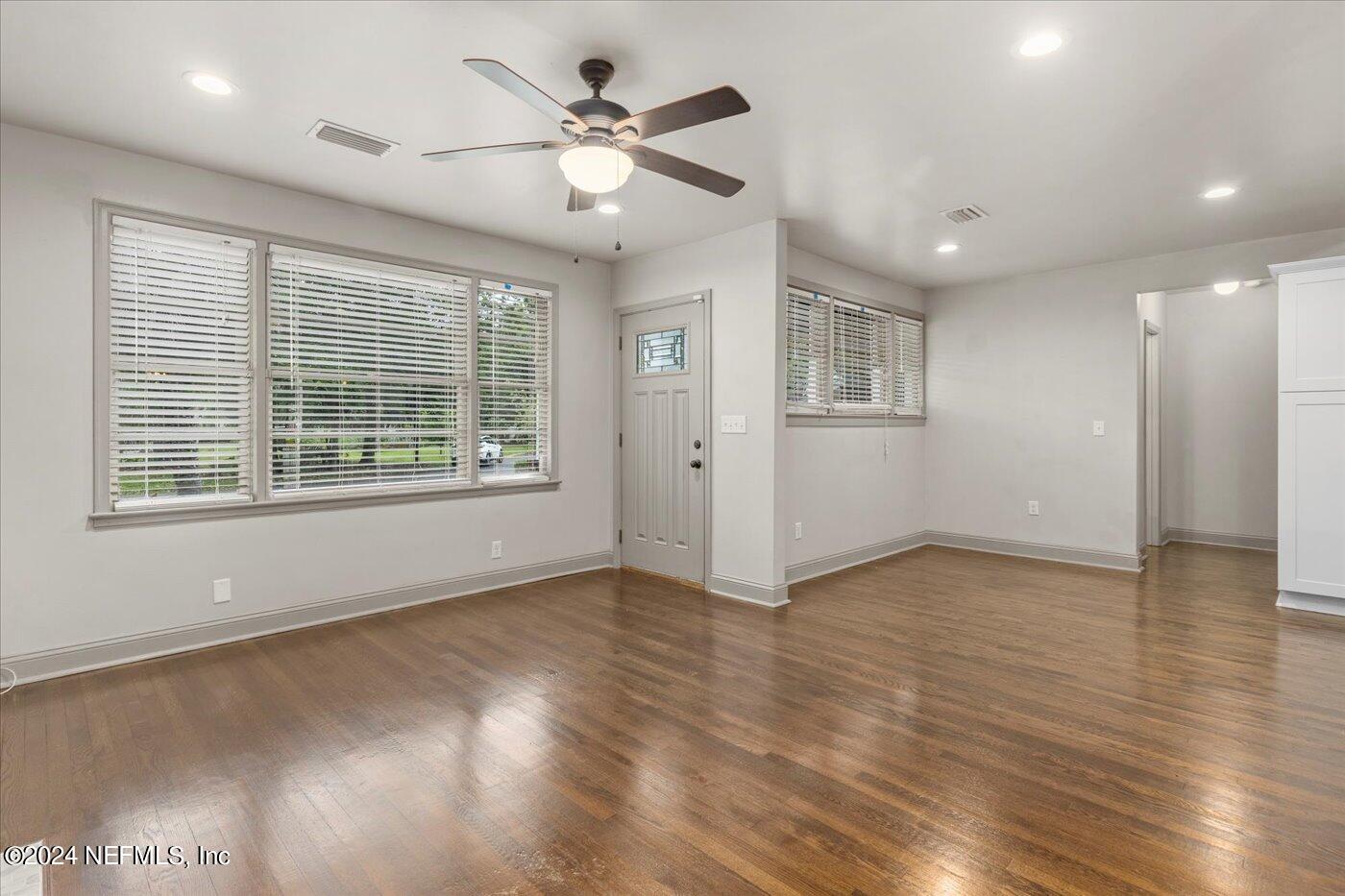 1273 Lechlade Circle Jacksonville, FL 32205 - Photo 7 of 33 a view of an empty room with wooden floor and a window