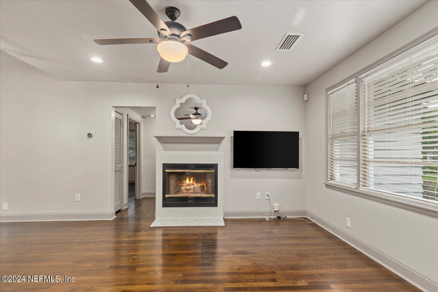 1273 Lechlade Circle Jacksonville, FL 32205 - Photo 9 of 33 a living room with a fireplace and a flat screen tv