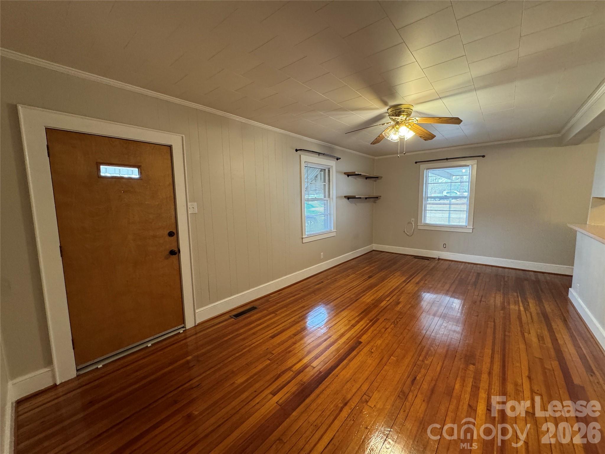 9019 Reames Road Charlotte, NC 28216 - Photo 2 of 7 an empty room with wooden floor and windows