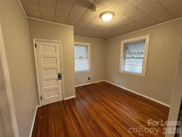 a view of a room with wooden floor and window