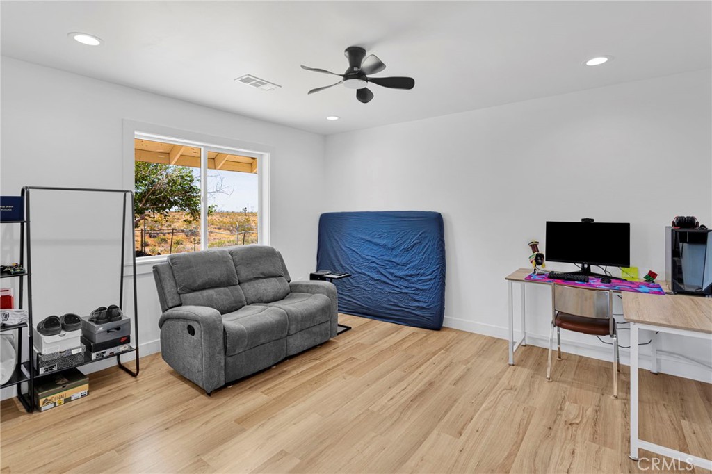 8038 Begonia Road Phelan, CA 92371 - Photo 26 of 49 a bedroom with furniture and a flat screen tv