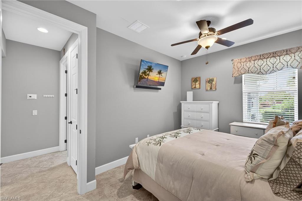 20105 Torch Key Way Estero, FL 33928 - Photo 18 of 29 a bedroom with a bed and a chandelier