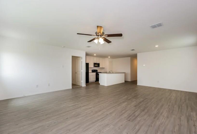 10225 Hackberry Spg Way Crowley, TX 76036 - Photo 3 of 11 Unfurnished living room featuring dark wood-style flooring, recessed lighting, and a ceiling fan