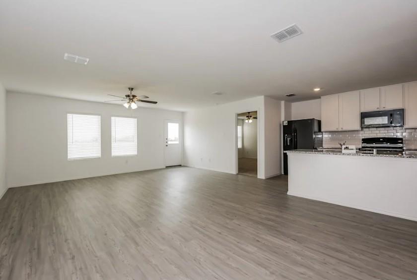 10225 Hackberry Spg Way Crowley, TX 76036 - Photo 11 of 11 Kitchen with open floor plan, tasteful backsplash, white cabinets, black appliances, and ceiling fan