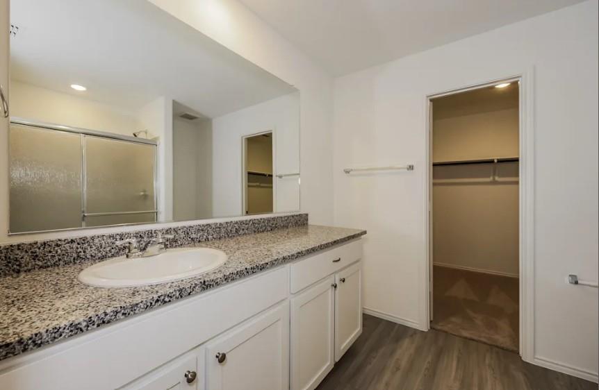 10225 Hackberry Spg Way Crowley, TX 76036 - Photo 9 of 11 Bathroom with a spacious closet, dark wood-type flooring, vanity, a shower stall, and recessed lighting