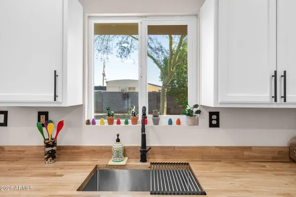 a kitchen with a window and cabinets