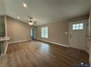 306 Barefords Mill Road Dunnsville, VA 22454 - Photo 11 of 11 an empty room with wooden floor and windows