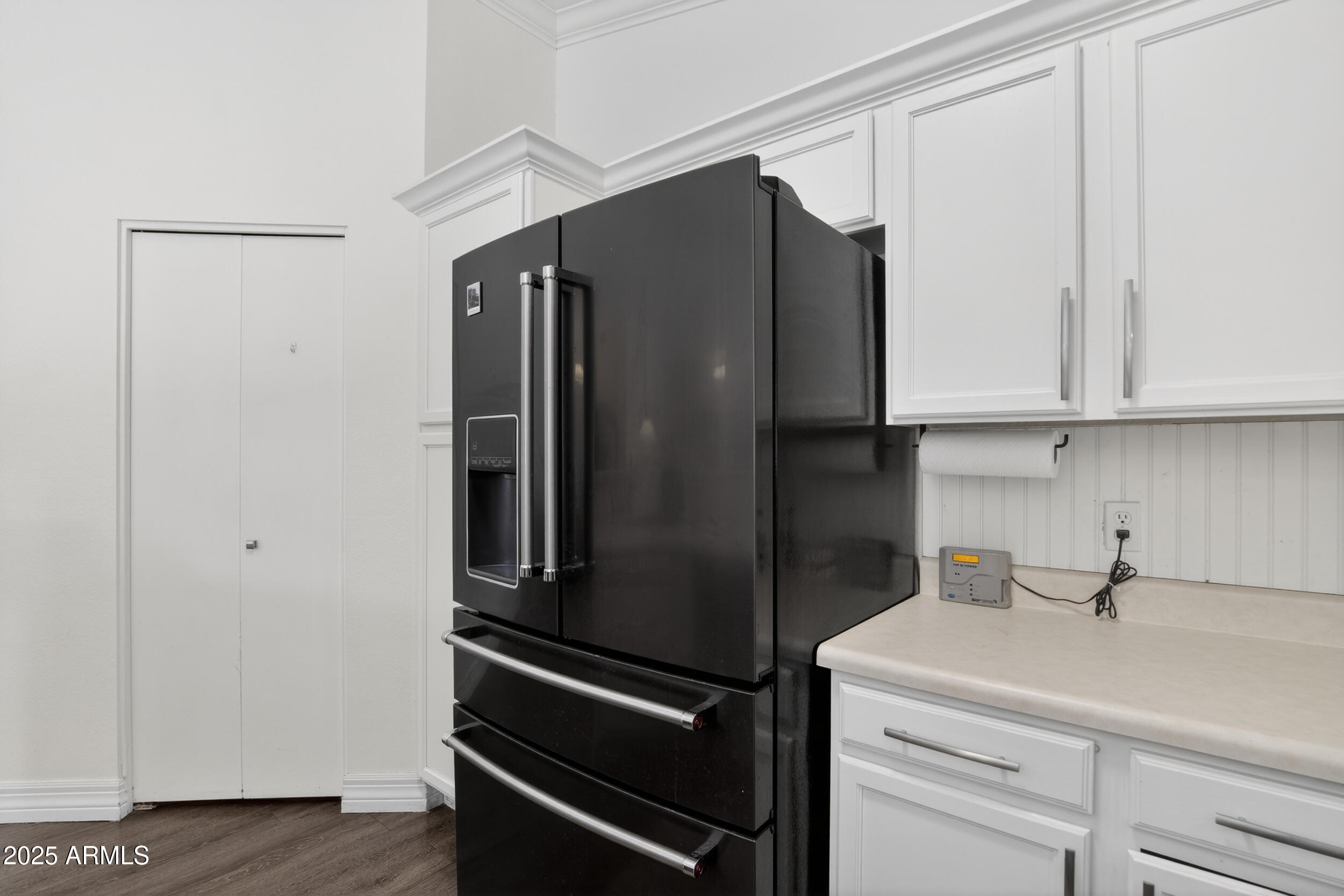 8429 West Coronado Road Phoenix, AZ 85037 - Photo 11 of 37 a kitchen with metallic refrigerator and cabinets