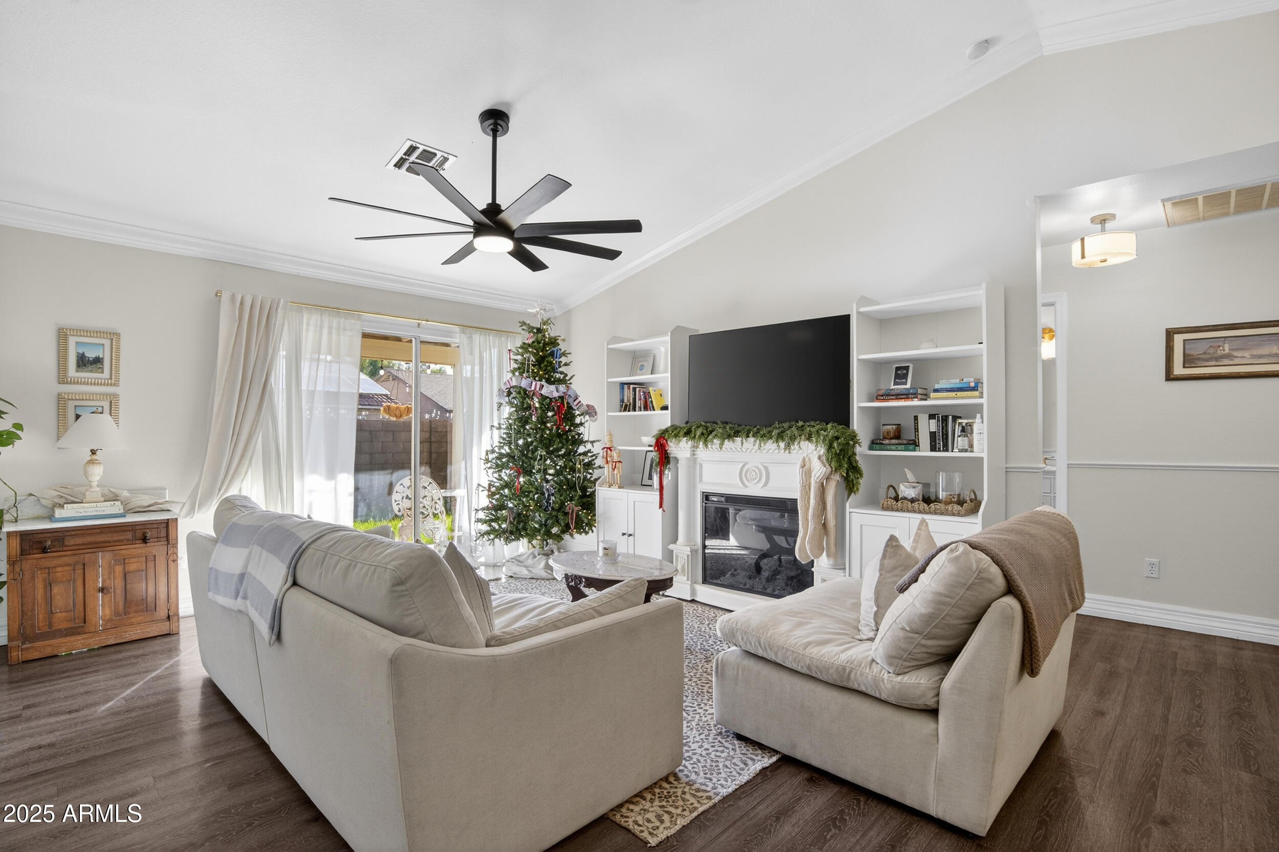 8429 West Coronado Road Phoenix, AZ 85037 - Photo 13 of 37 a living room with furniture a fireplace and a flat screen tv