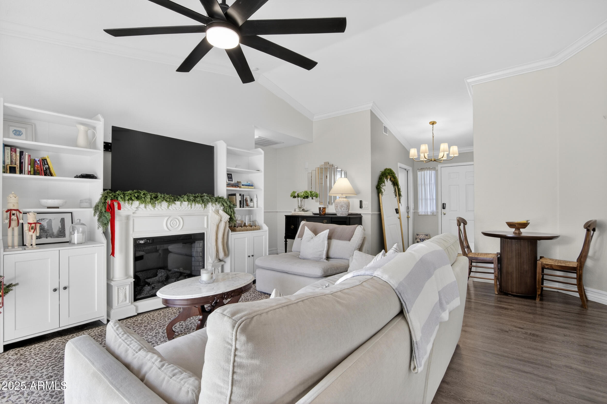 8429 West Coronado Road Phoenix, AZ 85037 - Photo 16 of 37 a living room with furniture a fireplace and a flat screen tv