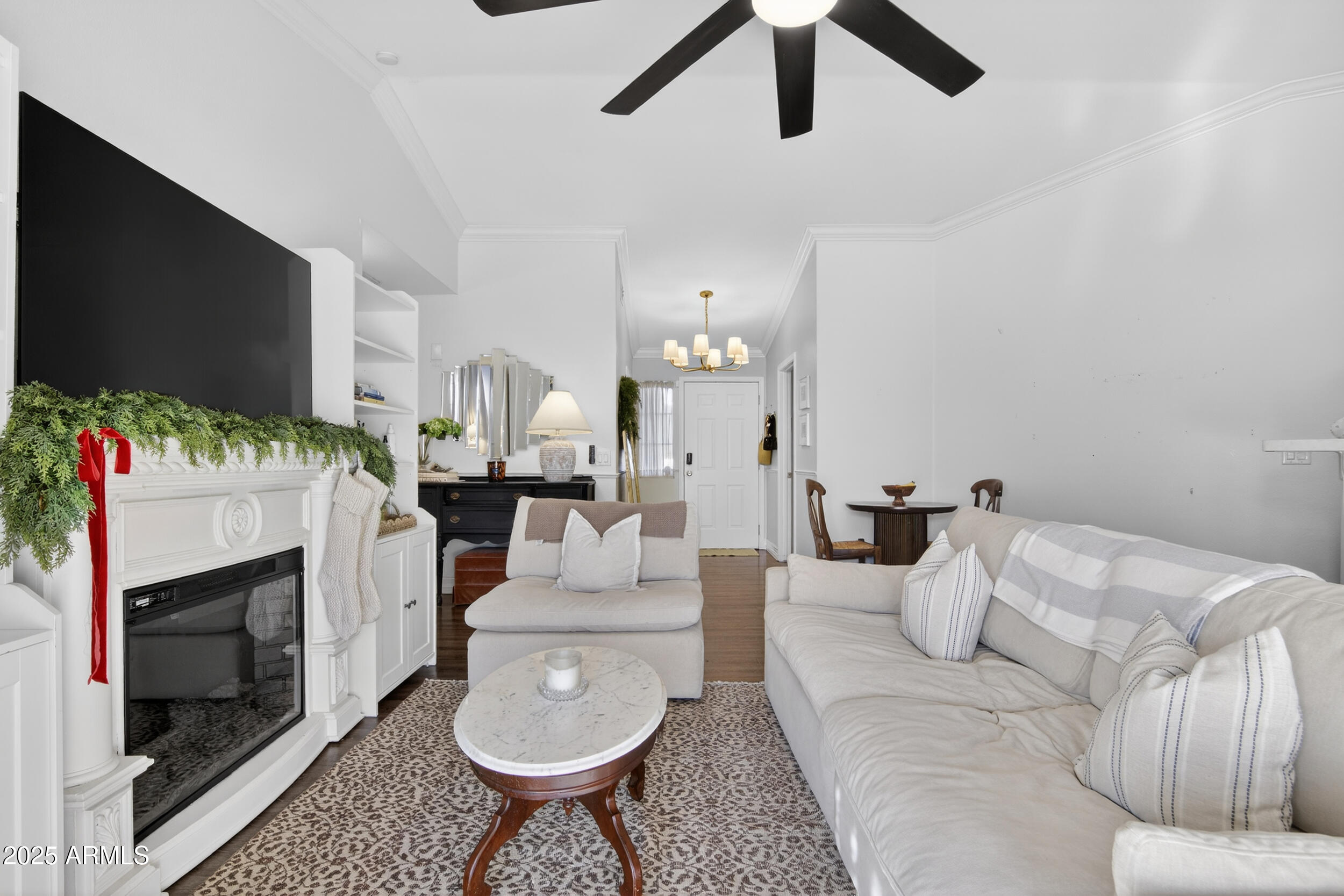 8429 West Coronado Road Phoenix, AZ 85037 - Photo 17 of 37 a living room with furniture a fireplace and a flat screen tv