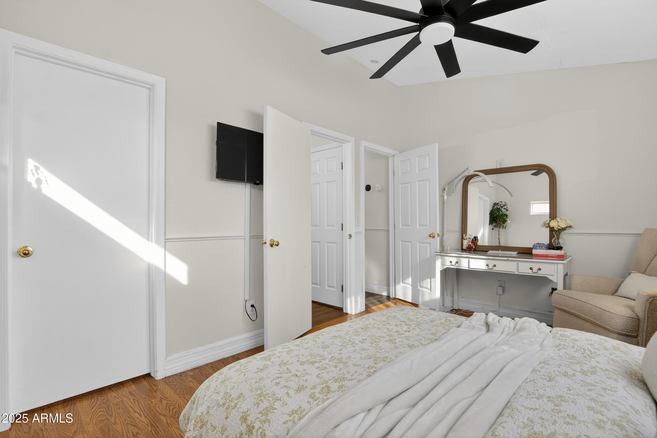 8429 West Coronado Road Phoenix, AZ 85037 - Photo 19 of 37 a bedroom with a bed and a flat screen tv