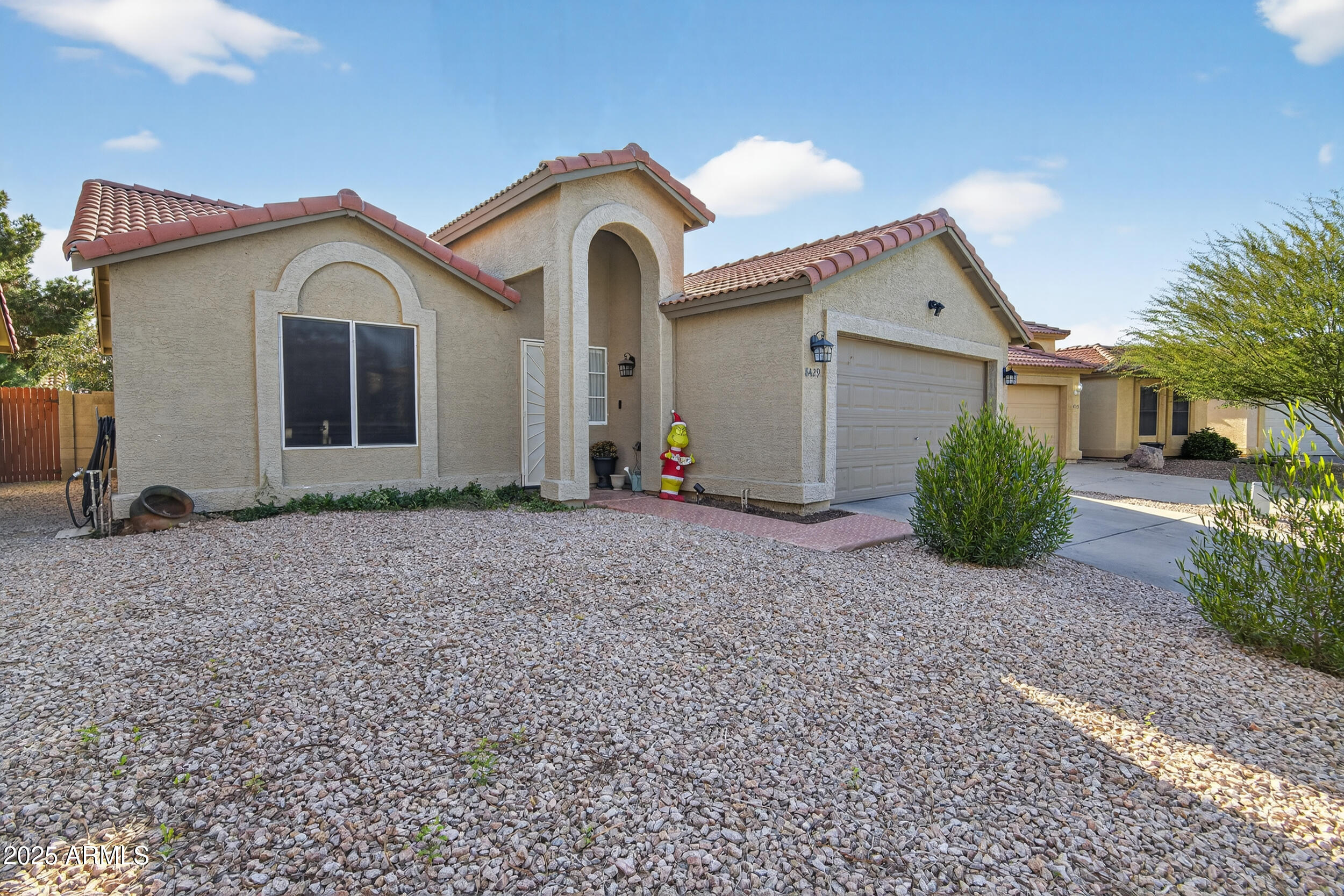 8429 West Coronado Road Phoenix, AZ 85037 - Photo 2 of 37 a view of a house with a yard and large tree