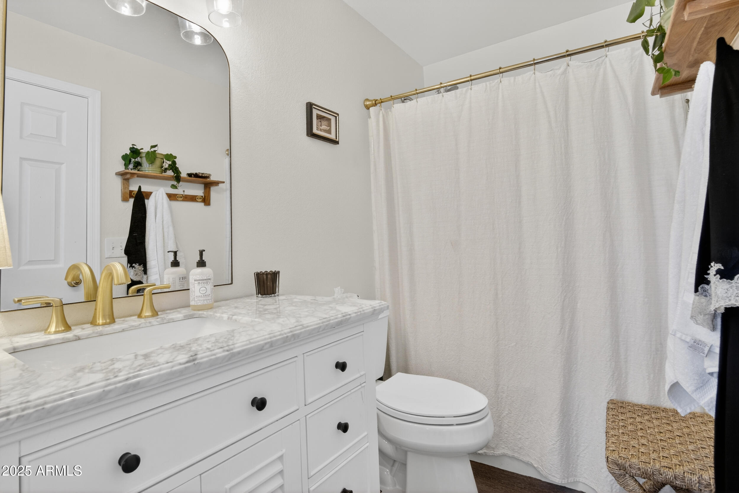 8429 West Coronado Road Phoenix, AZ 85037 - Photo 22 of 37 a bathroom with a granite countertop sink and a mirror