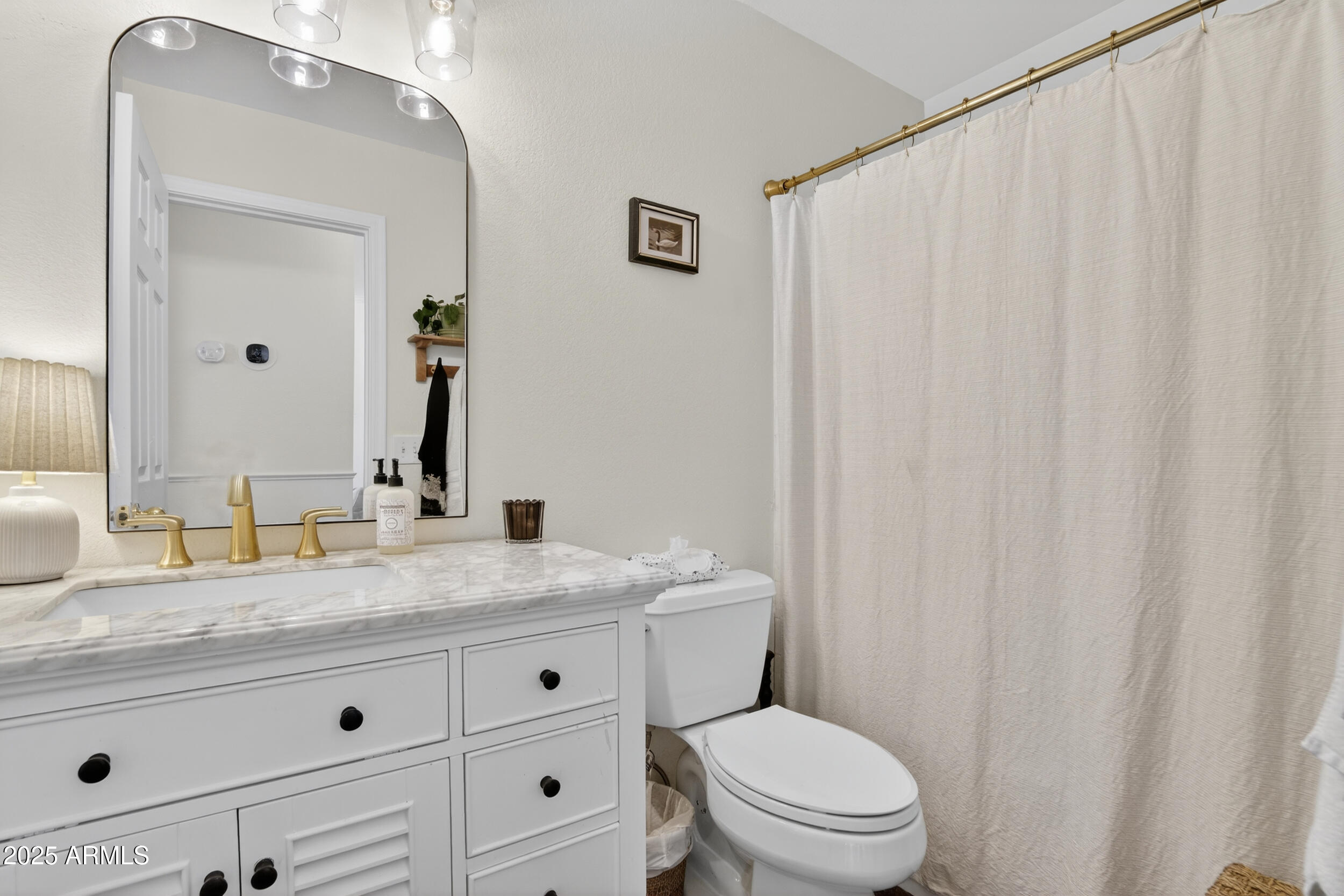 8429 West Coronado Road Phoenix, AZ 85037 - Photo 24 of 37 a bathroom with a granite countertop sink and a mirror