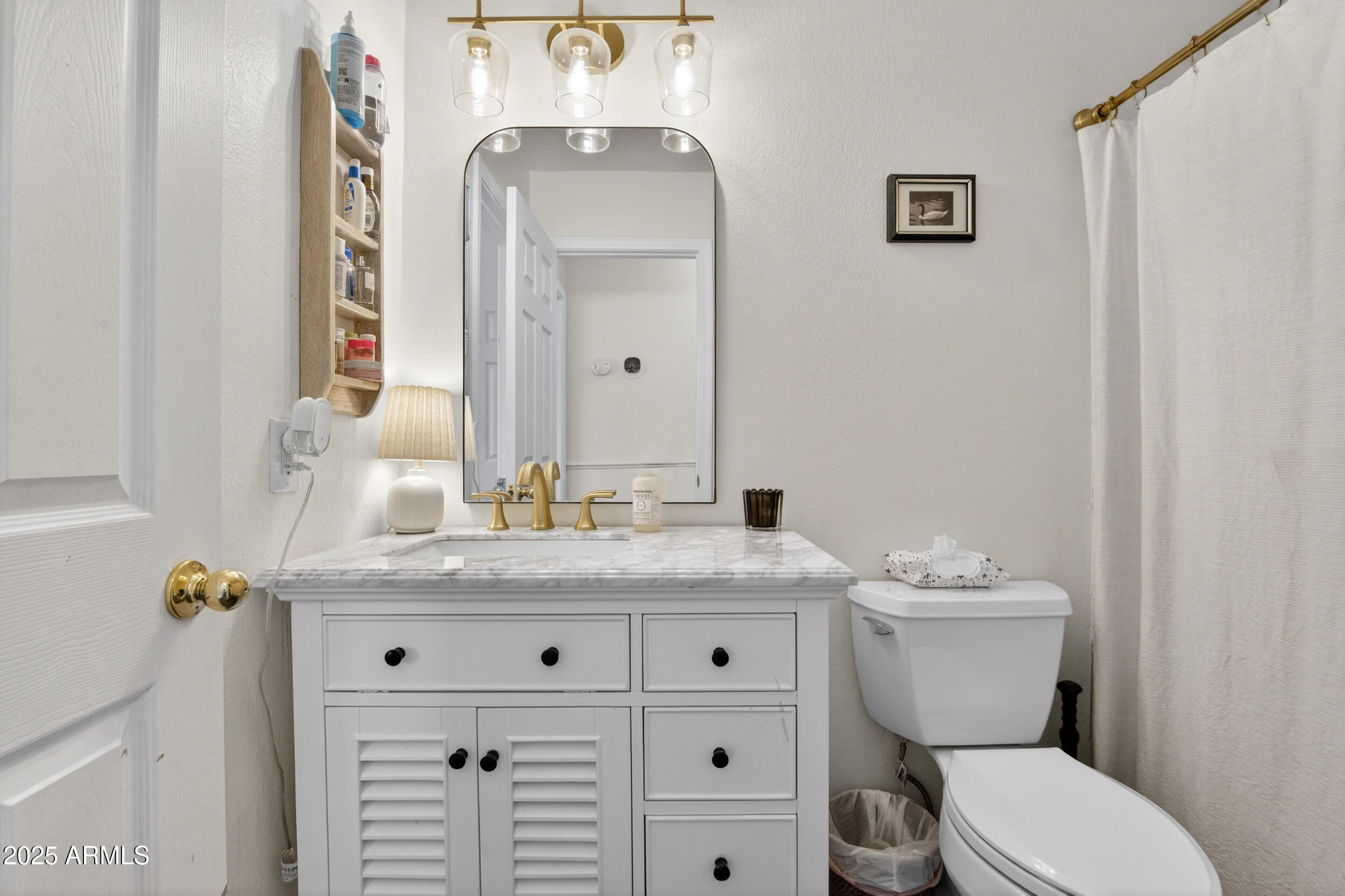 8429 West Coronado Road Phoenix, AZ 85037 - Photo 25 of 37 a bathroom with a granite countertop toilet sink and mirror