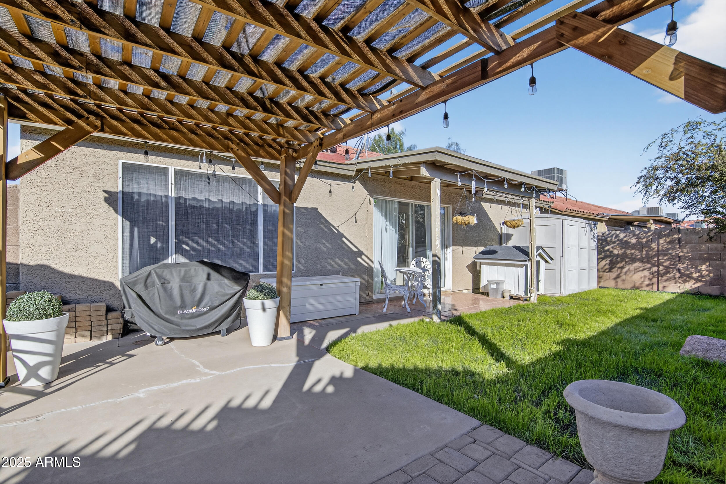 8429 West Coronado Road Phoenix, AZ 85037 - Photo 34 of 37 a view of a porch with furniture and a yard