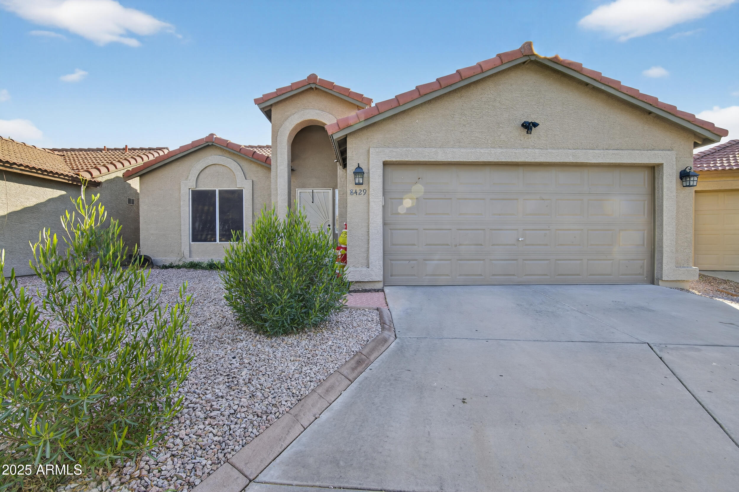 8429 West Coronado Road Phoenix, AZ 85037 - Photo 4 of 37 a front view of a house with garden