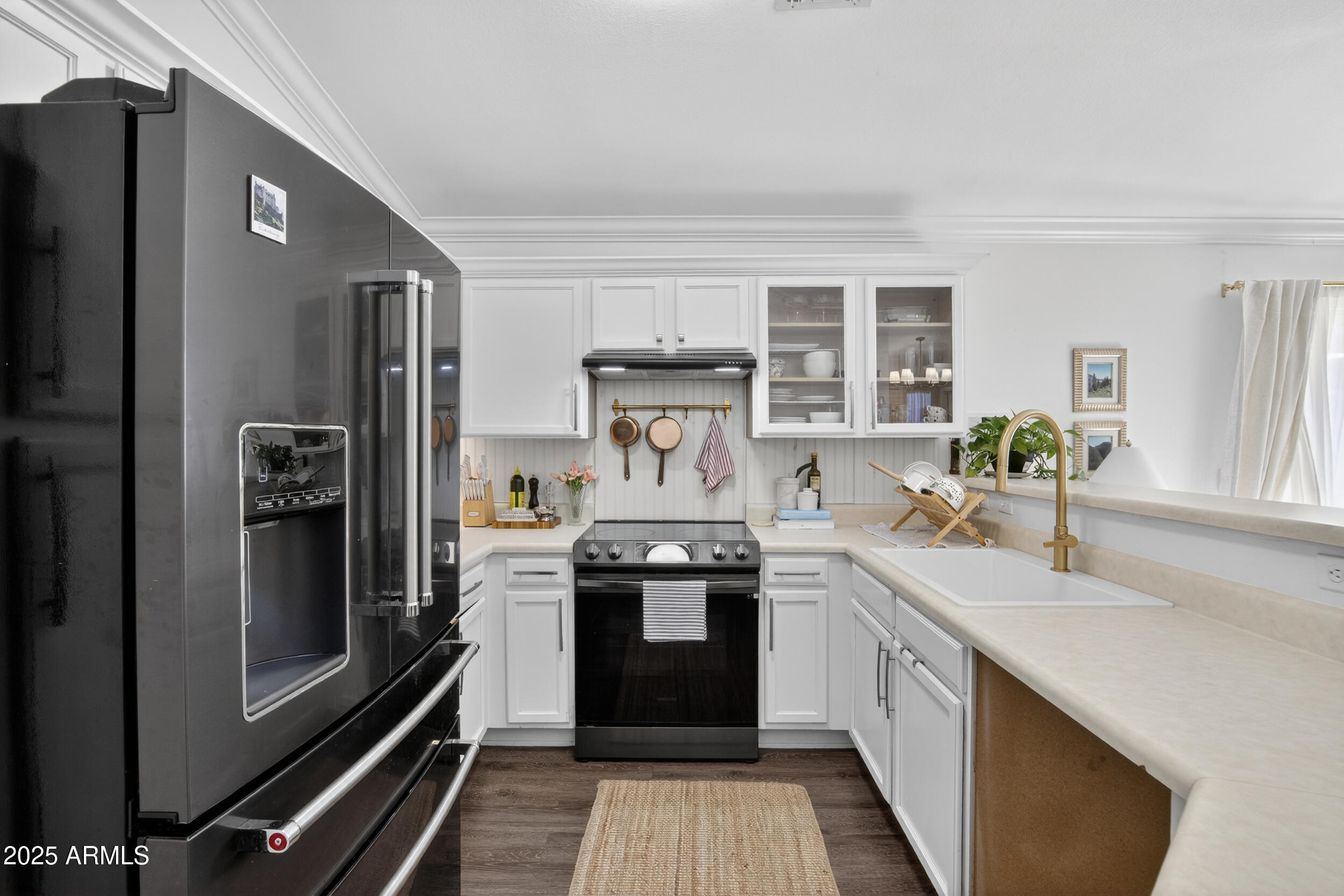 8429 West Coronado Road Phoenix, AZ 85037 - Photo 7 of 37 a kitchen with stainless steel appliances a refrigerator sink and stove