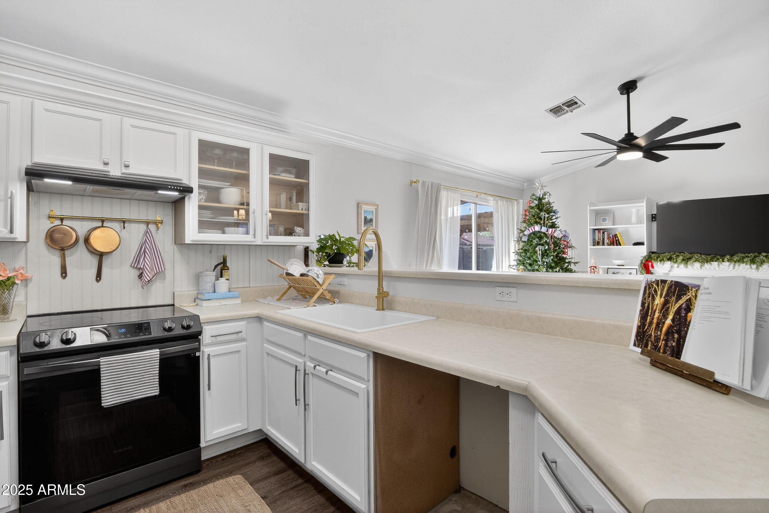 8429 West Coronado Road Phoenix, AZ 85037 - Photo 9 of 37 a kitchen with a stove a sink and a refrigerator