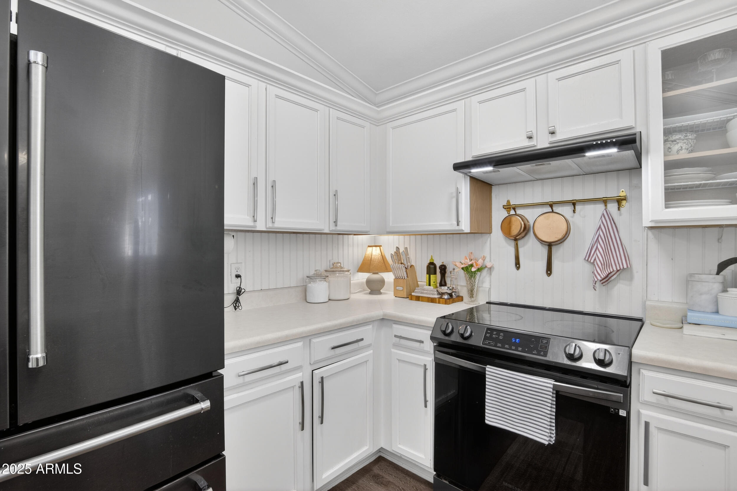 8429 West Coronado Road Phoenix, AZ 85037 - Photo 10 of 37 a kitchen with stainless steel appliances granite countertop a sink and a stove