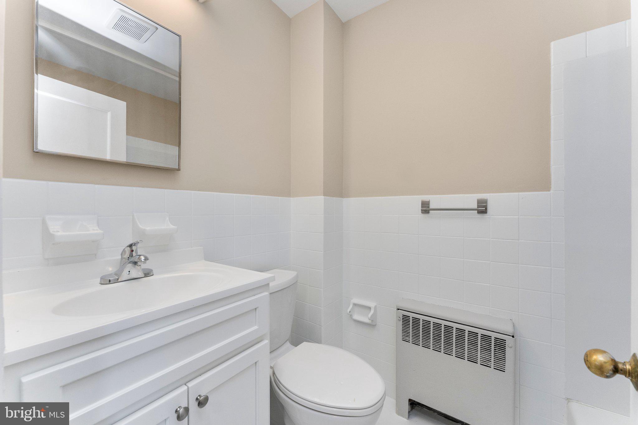 5346 Chew Avenue, Unit 2B Philadelphia, PA 19138 - Photo 13 of 18 a bathroom with a sink a toilet and mirror