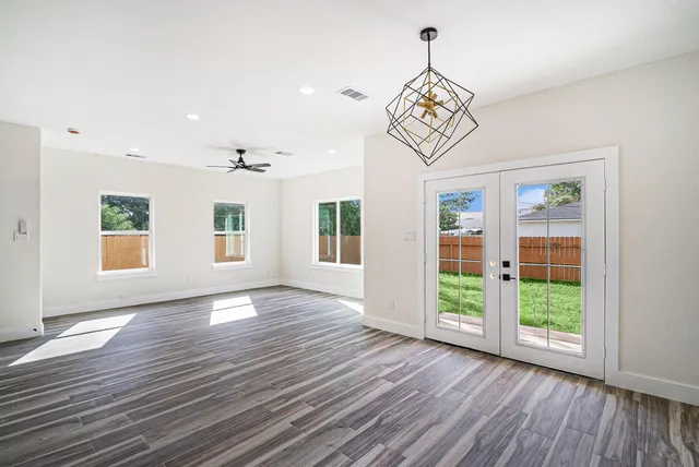 a view of a kitchen with wooden floor and a sink