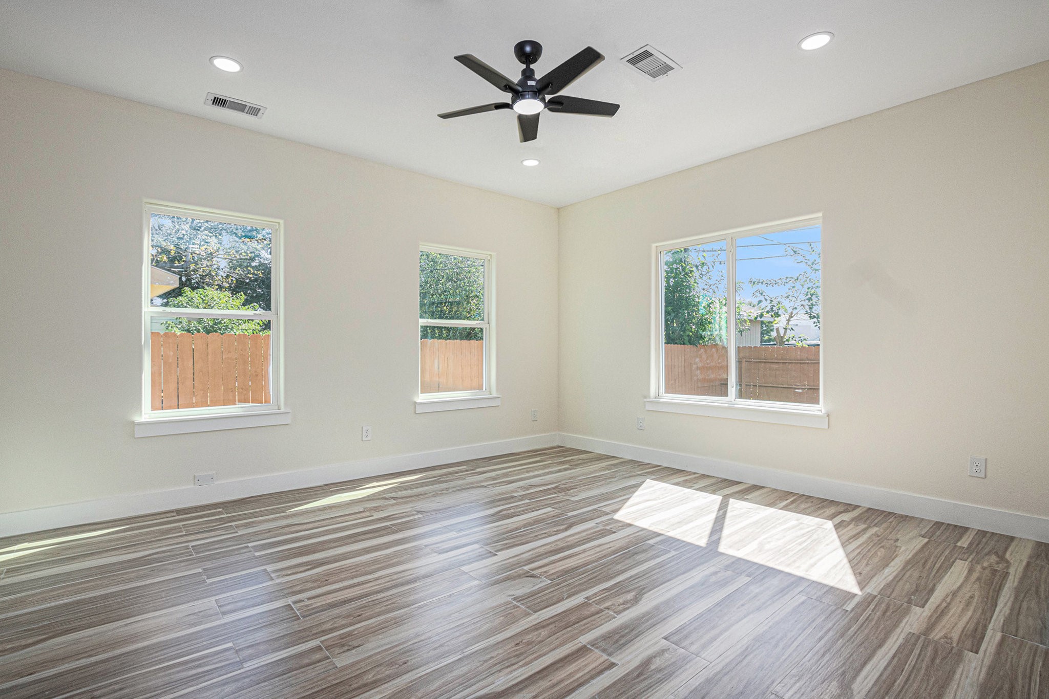9807 Bamboo Road Houston, TX 77041 - Photo 19 of 37 an empty room with wooden floor and windows