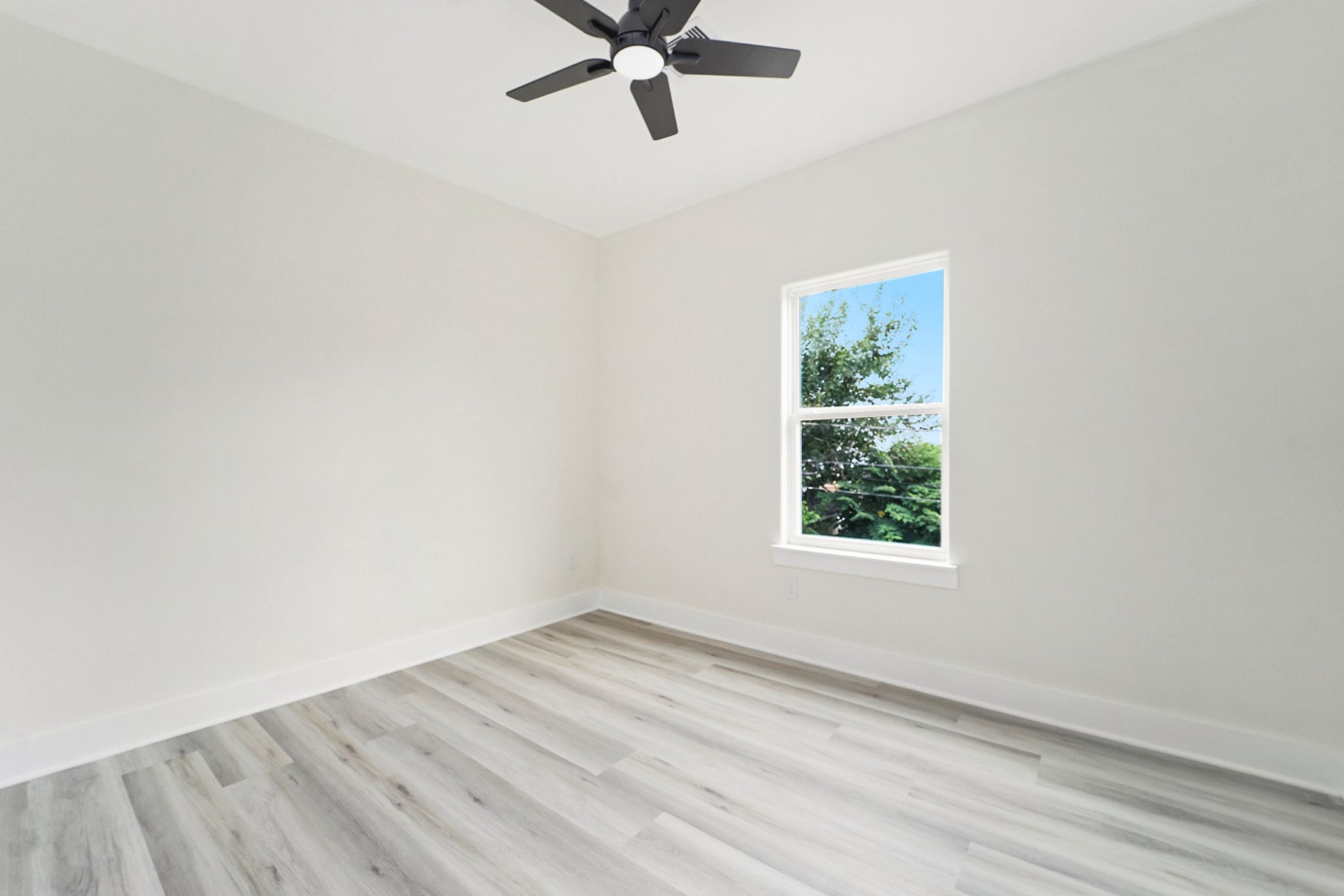 9807 Bamboo Road Houston, TX 77041 - Photo 20 of 37 an empty room with a window and a ceiling fan
