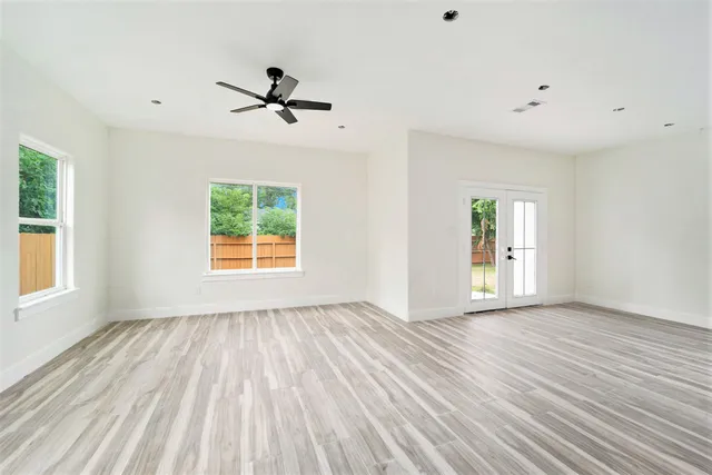 wooden floor in an empty room with a window