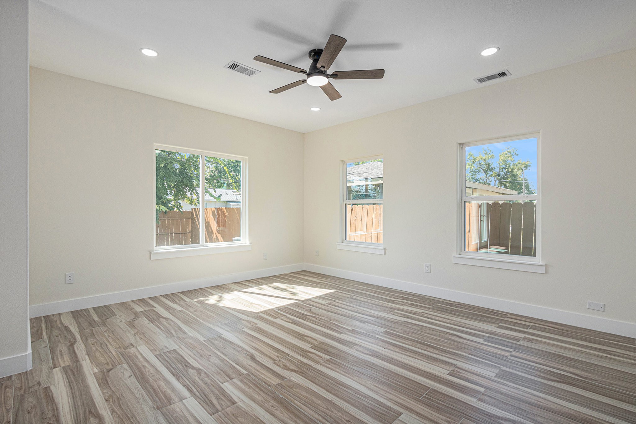 9807 Bamboo Road Houston, TX 77041 - Photo 27 of 37 a view of an empty room with wooden floor and a window