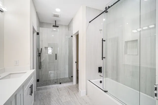 a bathroom with a shower and a tub