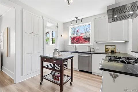 a kitchen with stainless steel appliances a stove a sink and a refrigerator