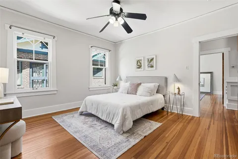 a bedroom with a large bed chandelier and a window